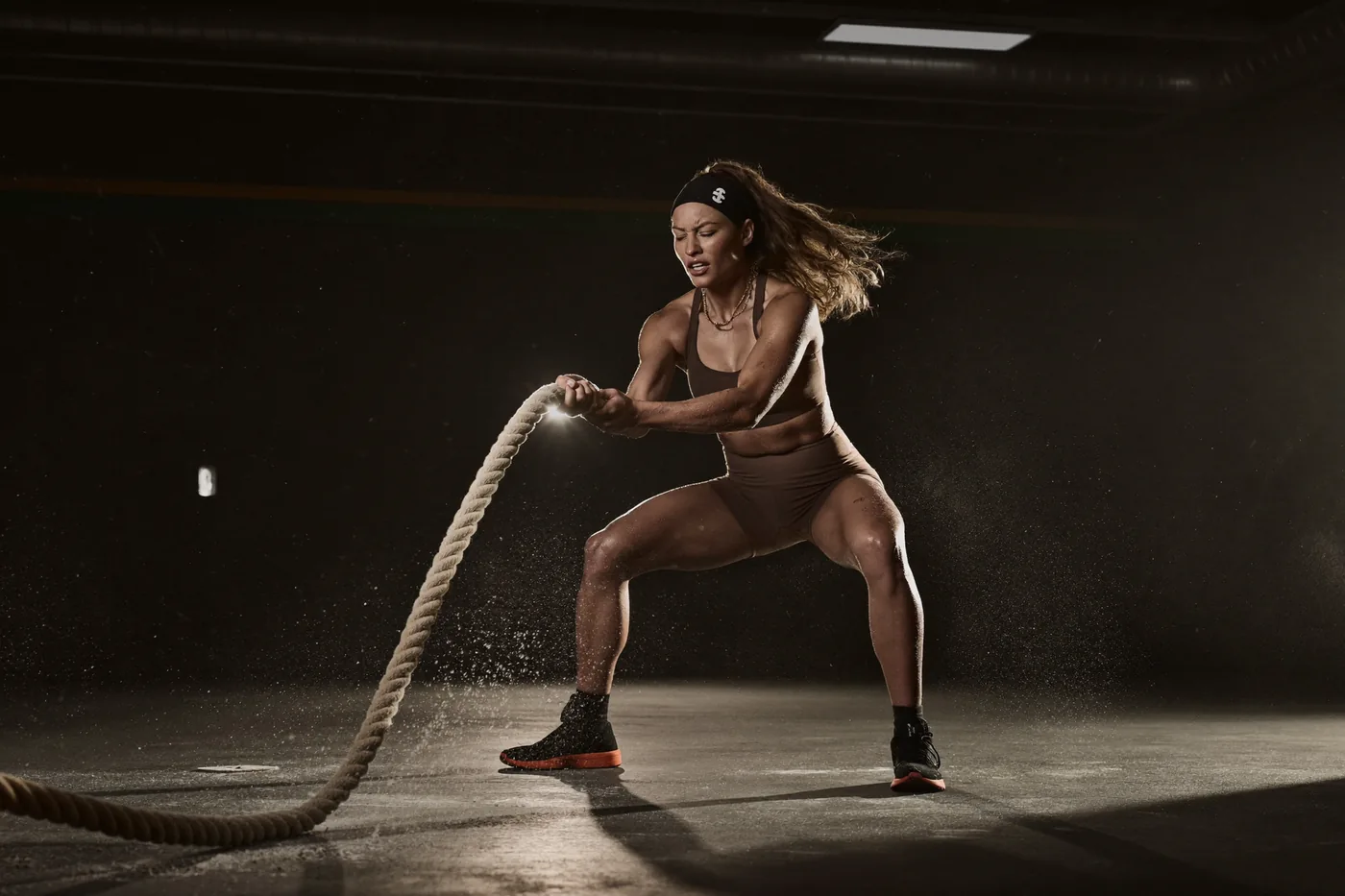 Woman training hard with battle ropes